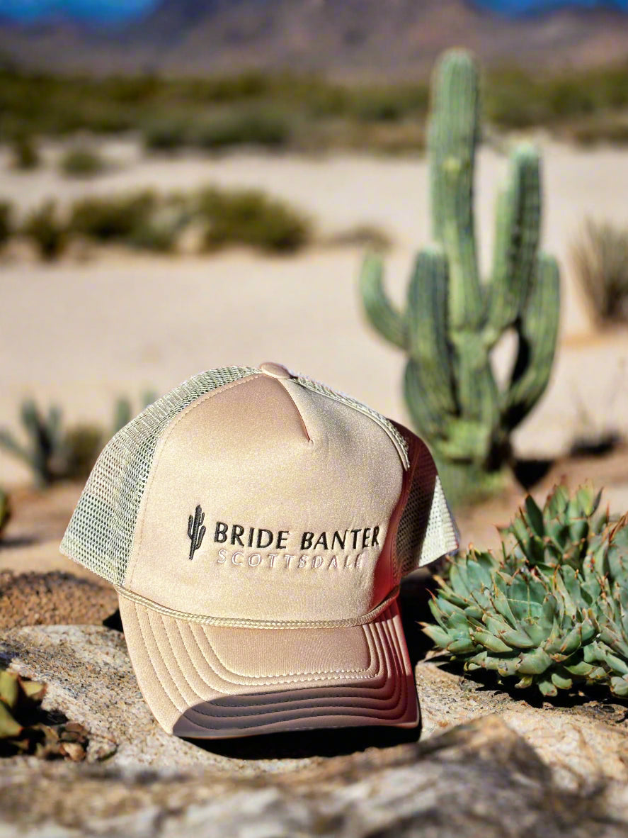 Beige trucker hat with Bride Banter Scottsdale and a cactus logo embroidered